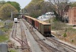 CSX train L619-05 heads south with loaded woodchip hoppers on the rear